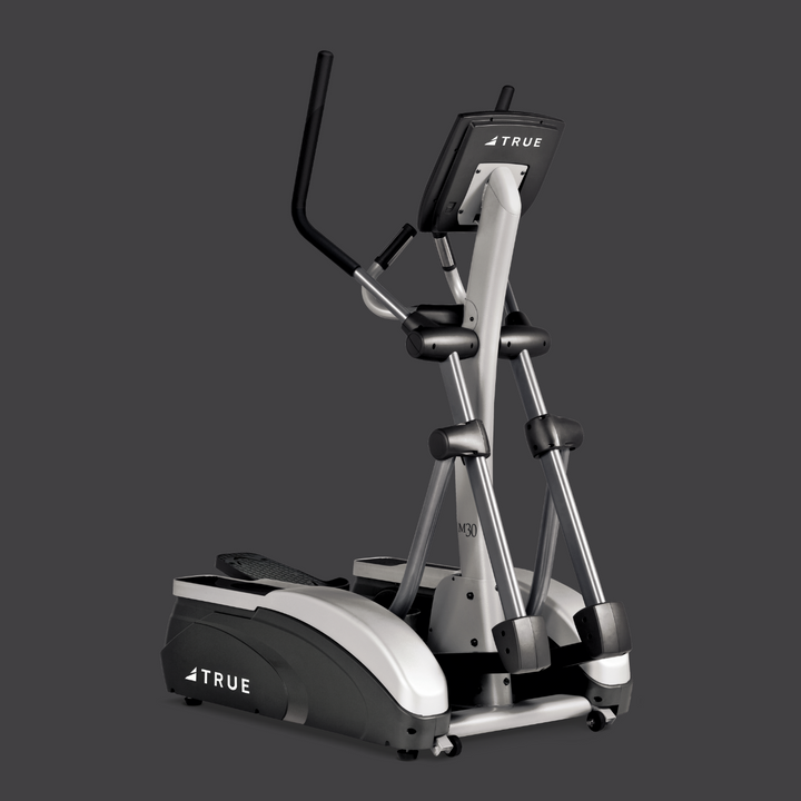 Angled view of TRUE M30 elliptical showing the frame, pedals, upright handles, and console