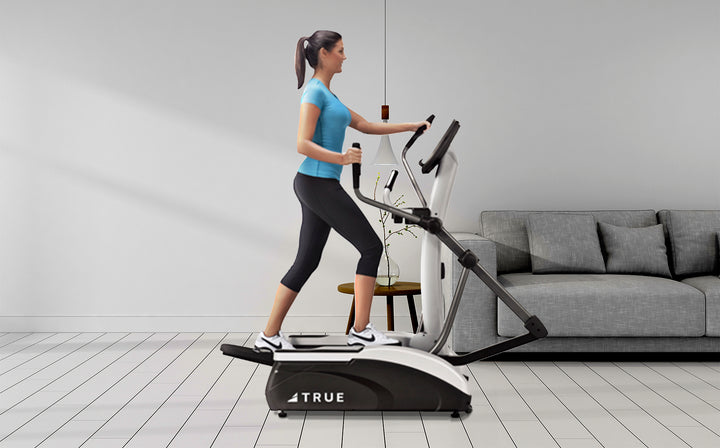 Person using the TRUE M30 elliptical in a home workout setting