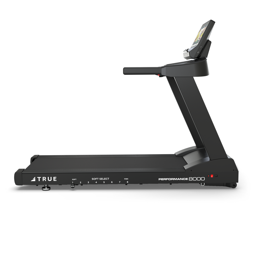 Side view of TRUE Performance 8000 treadmill showing the running deck, frame, and console.