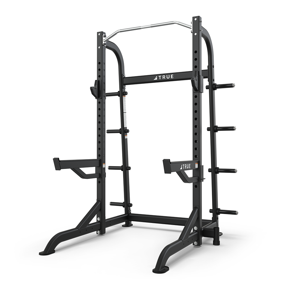 TRUE XFW-8100 half rack shown from a front angle with pull-up station, bar catches, and plate holders