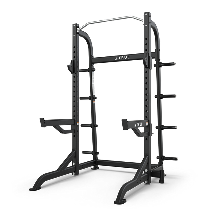 TRUE XFW-8100 half rack shown from a front angle with pull-up station, bar catches, and plate holders