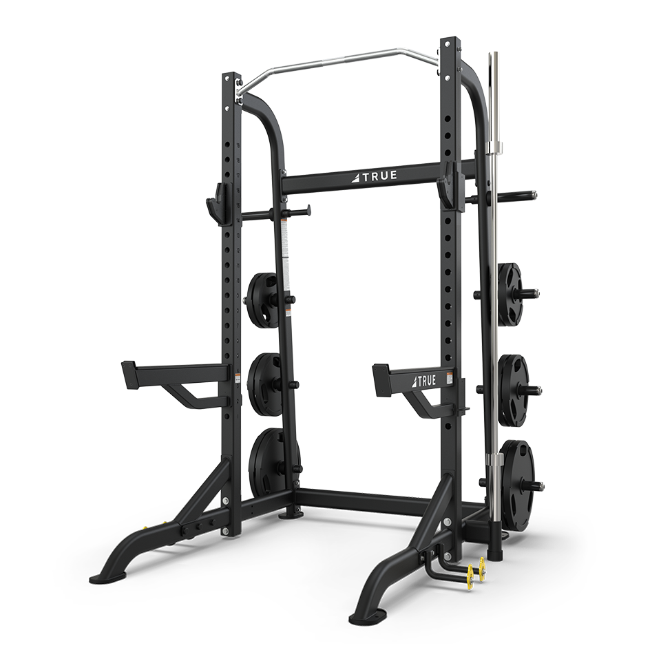 TRUE XFW-8100 half rack shown from a side angle with open-face frame, pull-up station, and plate storage
