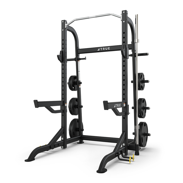 TRUE XFW-8100 half rack shown from a side angle with open-face frame, pull-up station, and plate storage