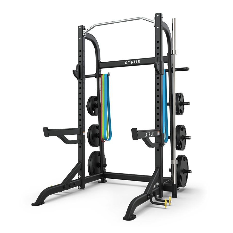 TRUE XFW-8100 half rack with plate holders, Olympic bar storage, pull-up station, and band peg kit shown