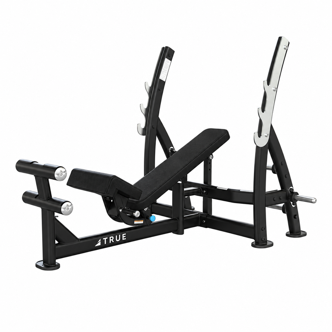 TRUE XFW-8200 3-way bench press with black upholstery, bar catches, footrest, and plate holders