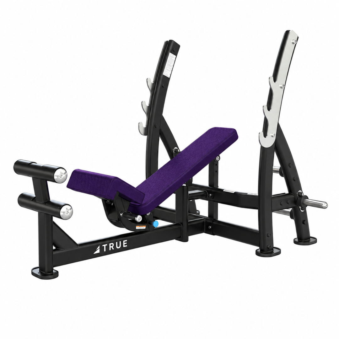 TRUE XFW-8200 3-way bench press with deep violet upholstery, bar catches, footrest, and plate holders  