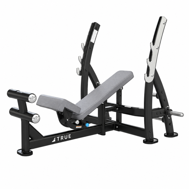 TRUE XFW-8200 3-way bench press with light gray upholstery, bar catches, footrest, and plate holders  