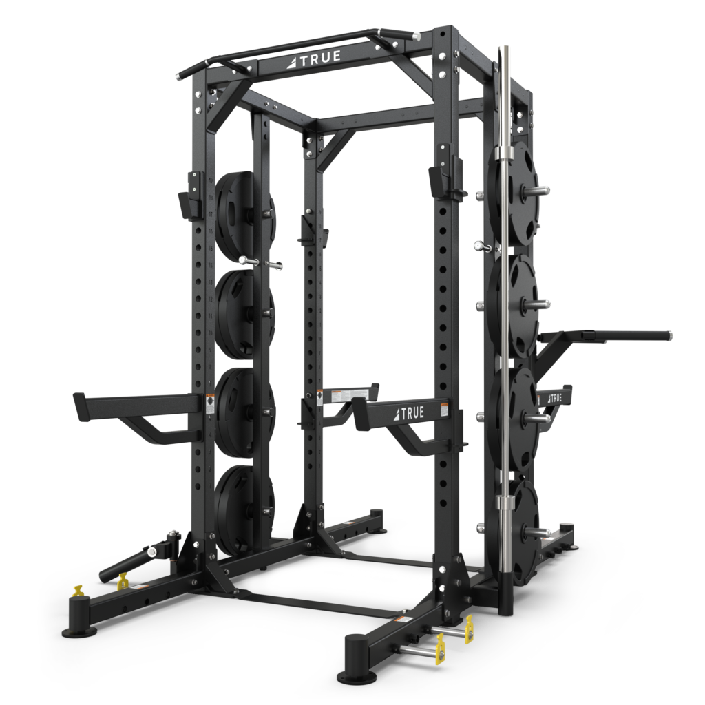 TRUE XFW-8300 dual-sided weight rack shown with weight plates, plate storage posts, Olympic bar storage, and chin bar