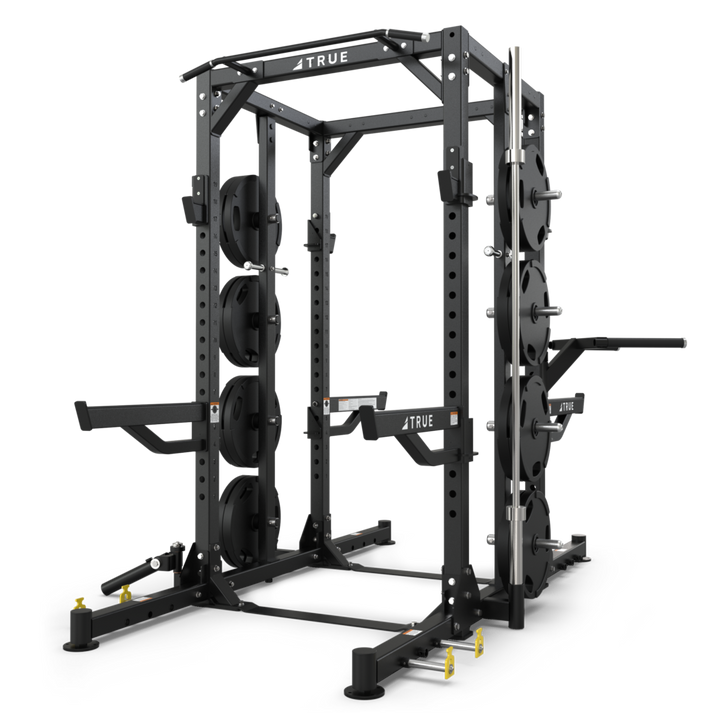 TRUE XFW-8300 dual-sided weight rack shown with weight plates, plate storage posts, Olympic bar storage, and chin bar