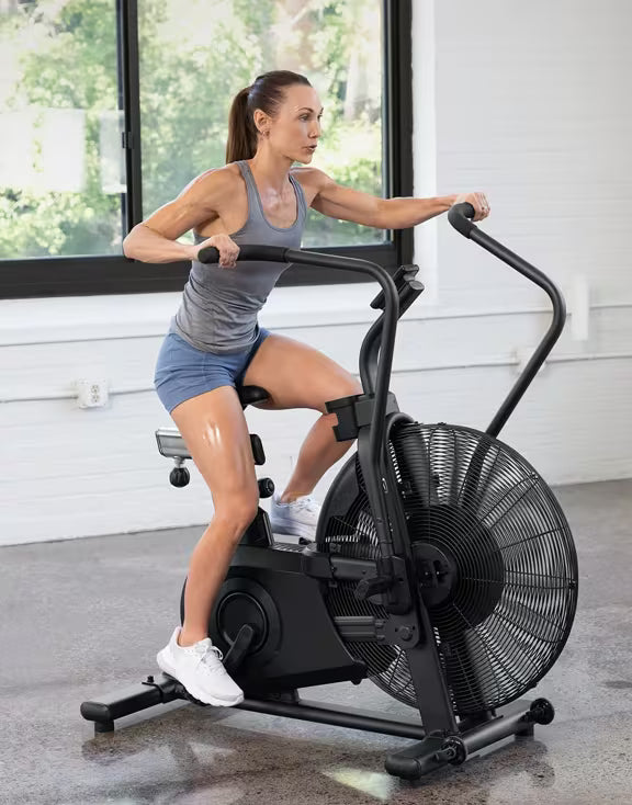 Person exercising on Vision Fitness AB700 air bike using the pedals and moving handlebars