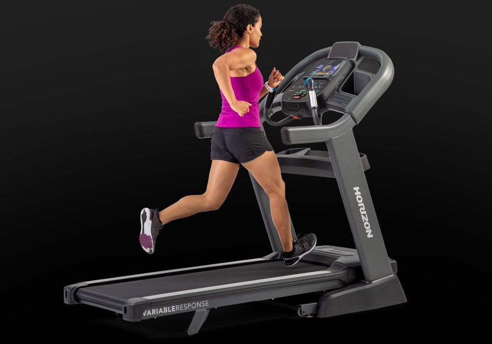 User walking on the Horizon Elite 7.0 AT treadmill during a workout.