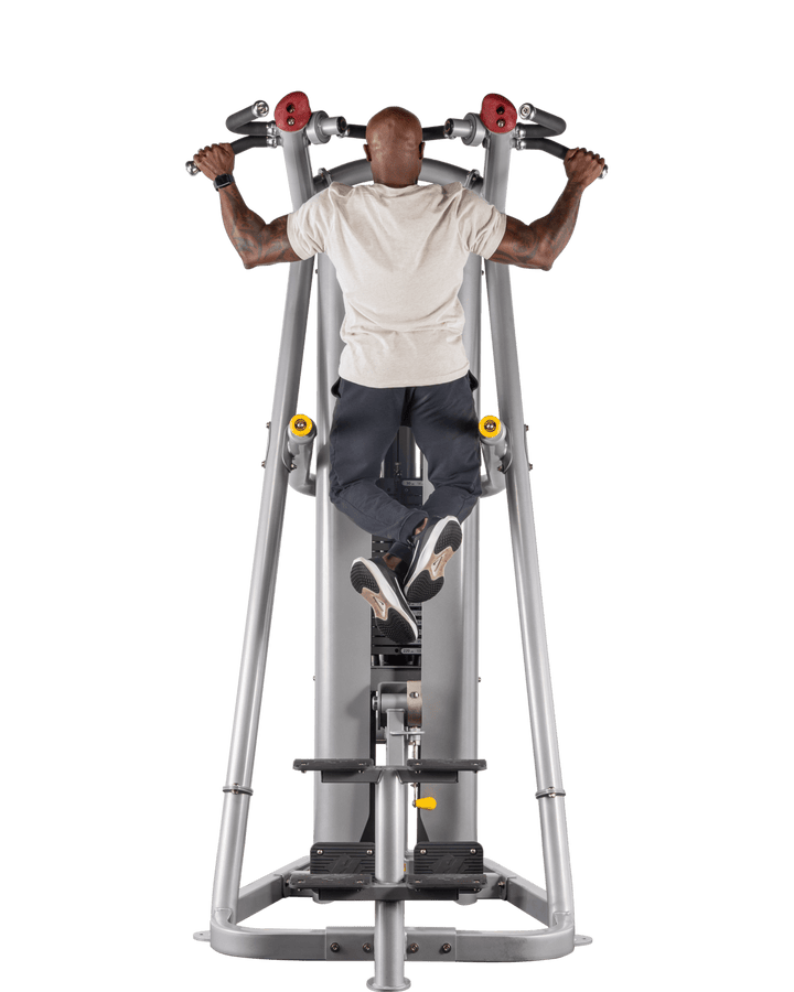 man performing pull-up on assisted machine showing full contraction at top position