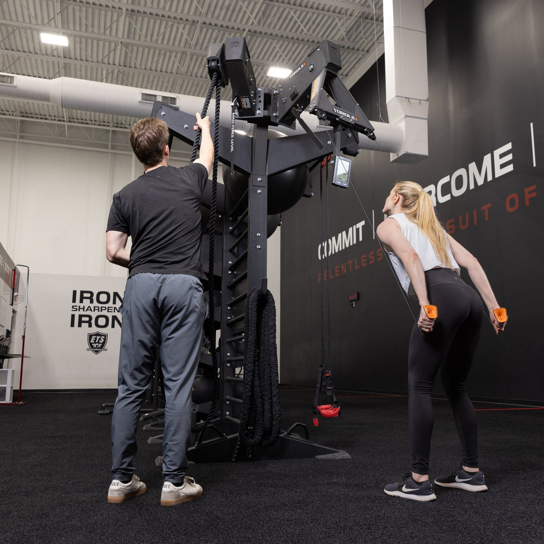 People demonstrating rope exercises on an X-CREATE station equipped with the Torque USA black side attachment mount.