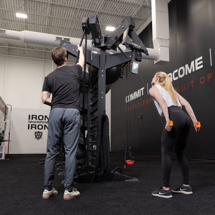 People demonstrating rope exercises on an X-CREATE station equipped with the Torque USA black side attachment mount.