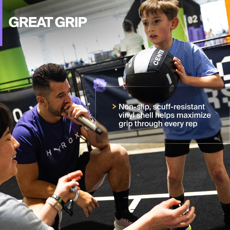 Young athlete practicing grip exercises with the Centr x HYROX Youngstars Wall Ball.