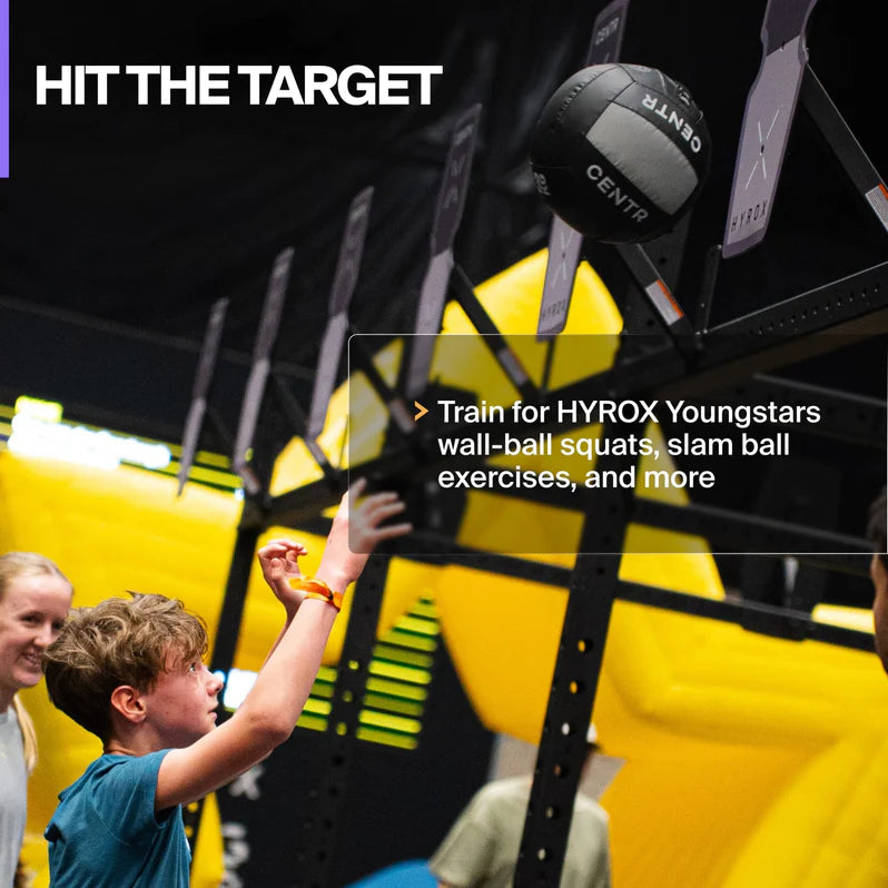 Young athlete using the Centr x HYROX Youngstars Wall Ball during target training.